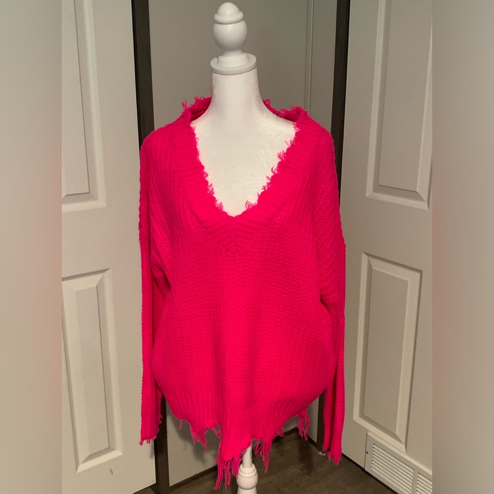 HOT PINK light sweater with jagged edges.
